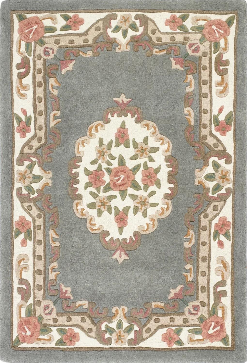 Decorative rug with floral patterns and a central medallion on a gray background