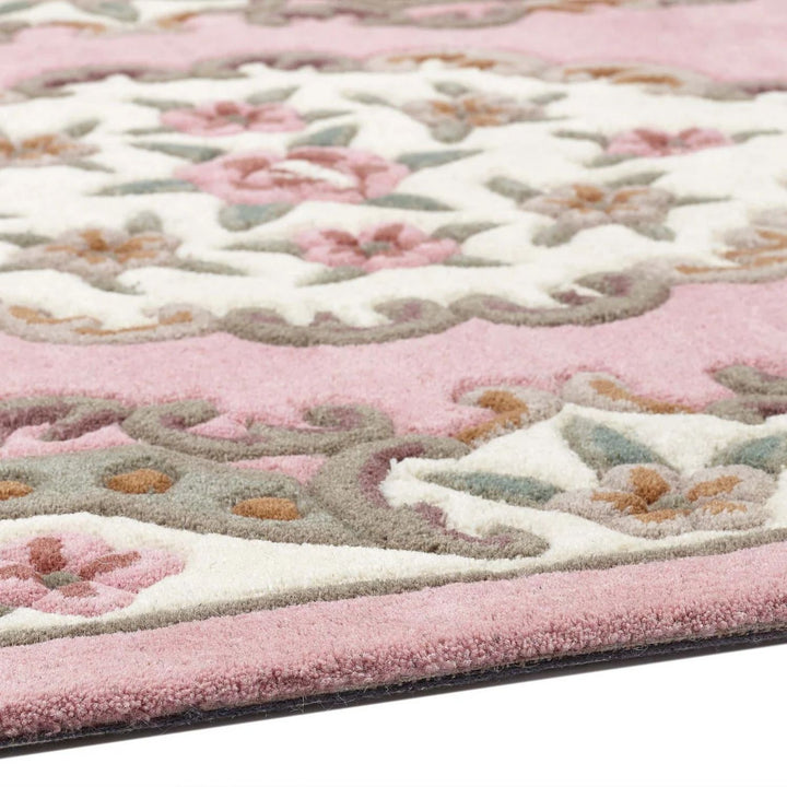 Close-up of a pink and white patterned rug with floral design
