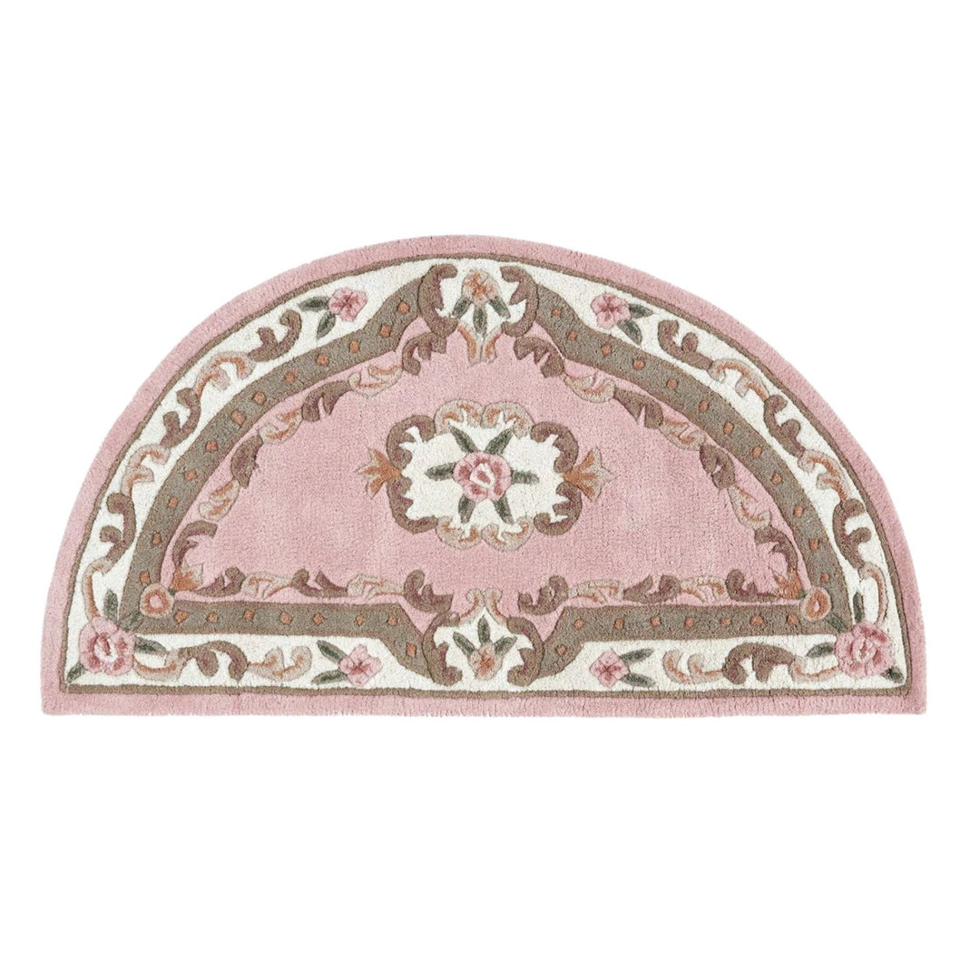 Decorative pink half-moon rug with floral patterns on a white background