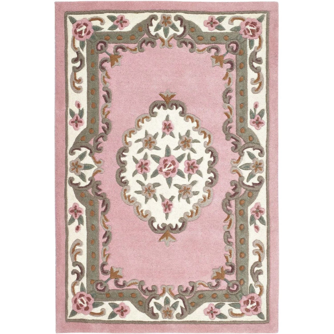 Decorative pink rug with floral patterns on a white background