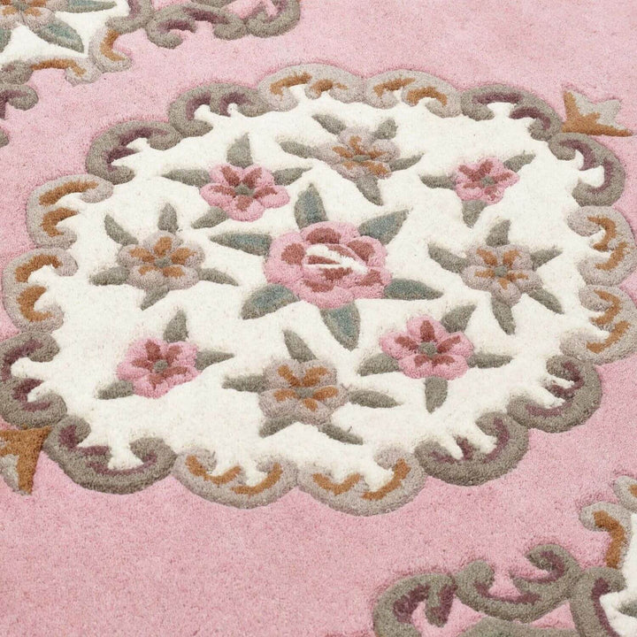 Close-up of a floral embroidered design on a pink background