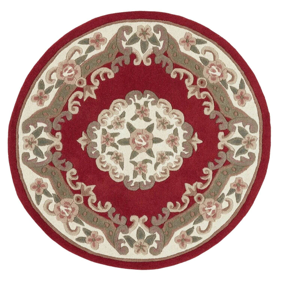 Round red area rug with floral patterns on a white background