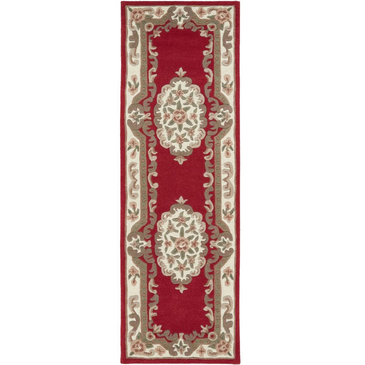 Decorative red and beige runner rug with intricate patterns on a white background