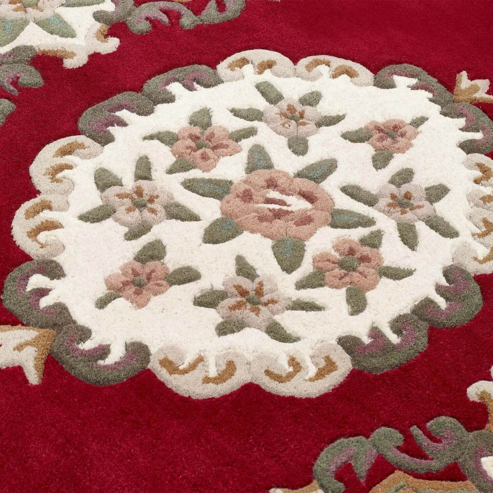 Decorative floral rug with a red background