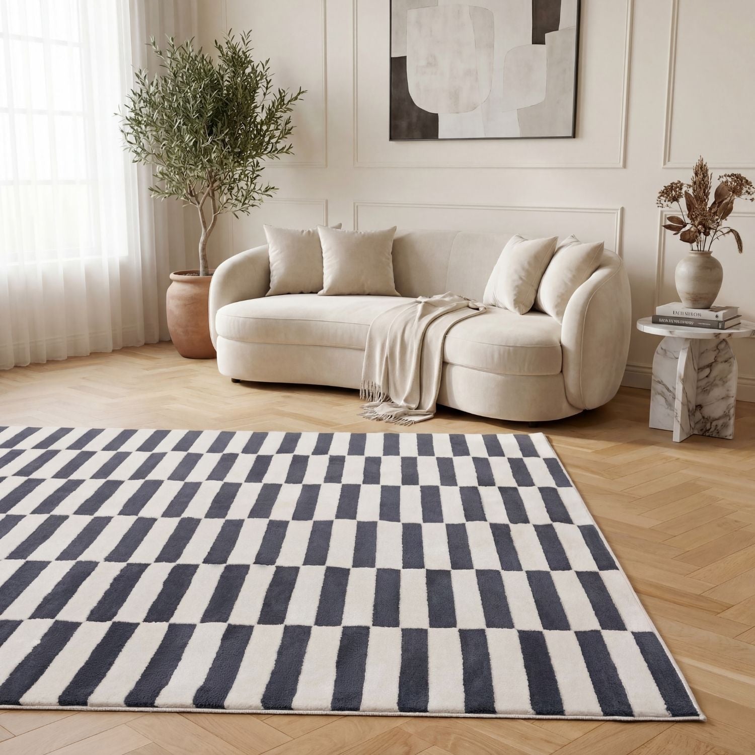 Living room with a white sofa, striped rug, and decorative elements.
