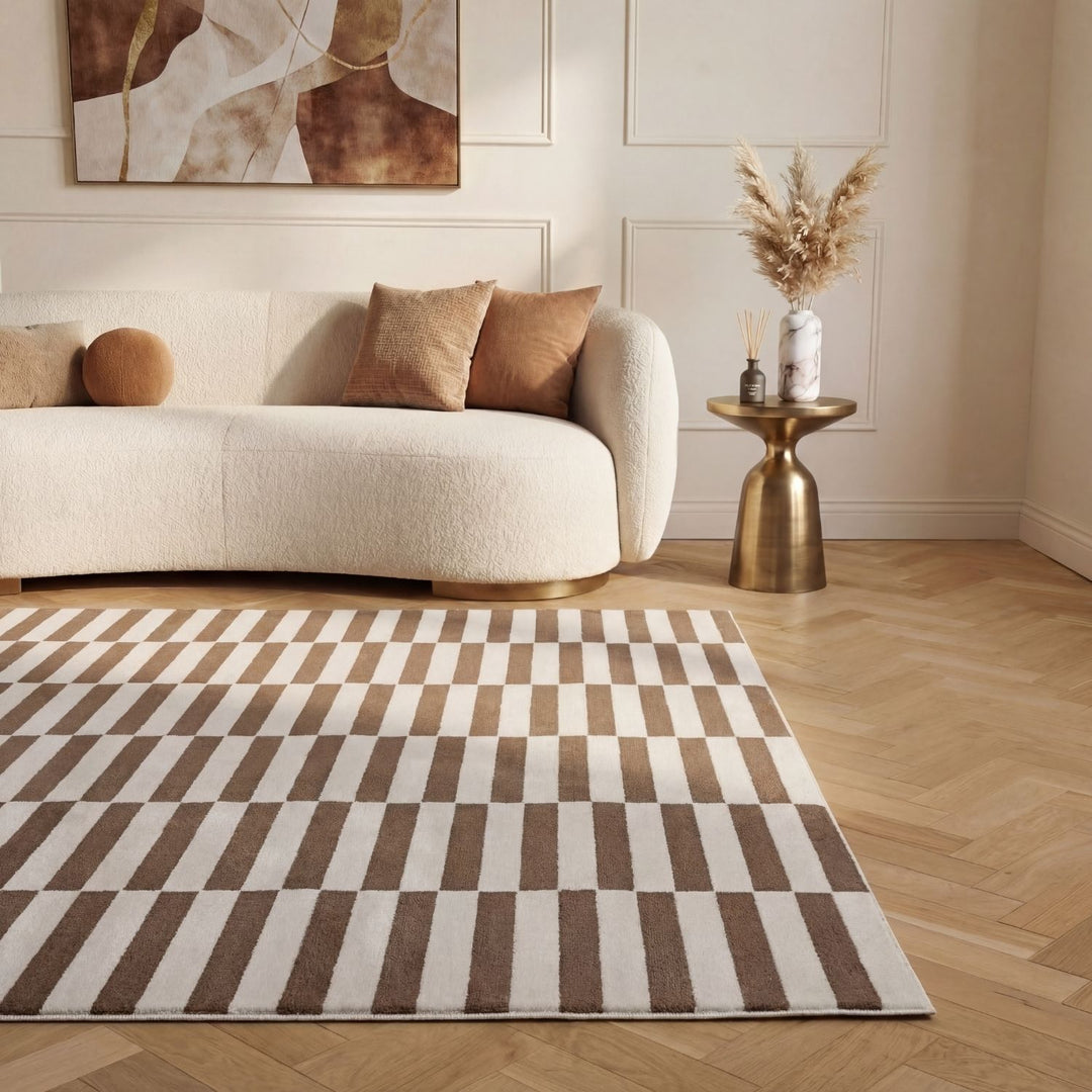 Living room with a beige sofa, patterned rug, and decorative elements.