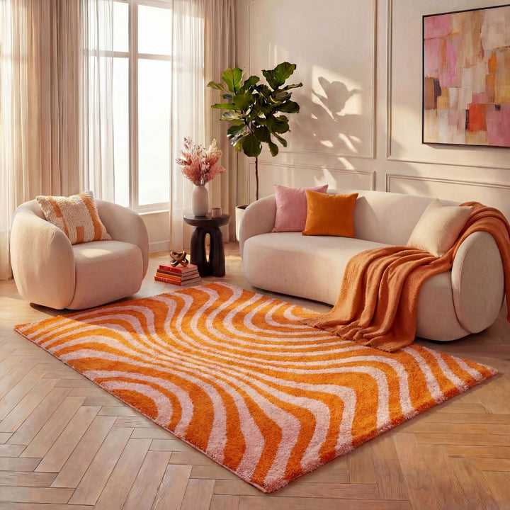 Living room with a white sofa, armchair, and orange patterned rug.