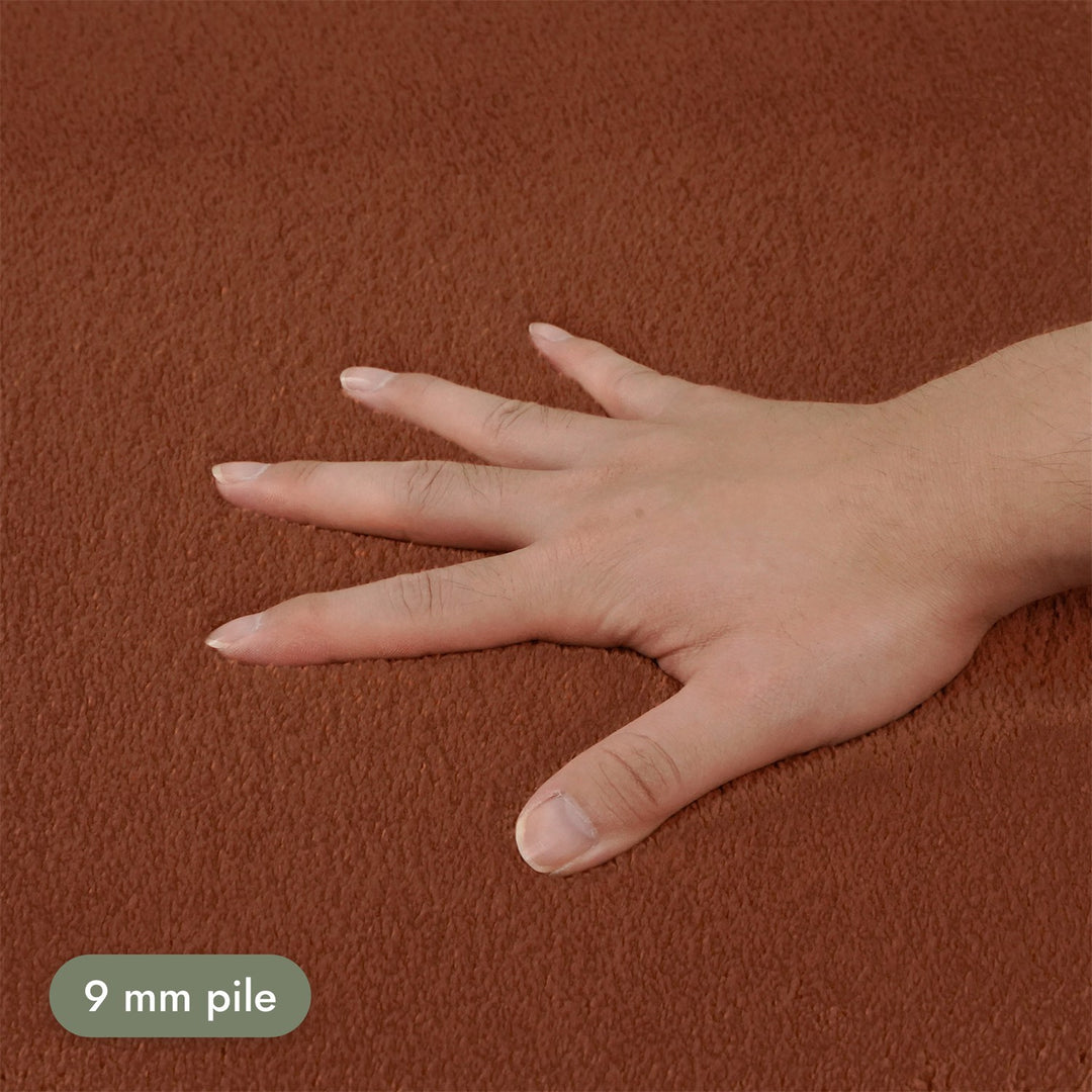 Washmellow terra washable rug, close-up of the soft 9mm pile under a hand | The Rugs