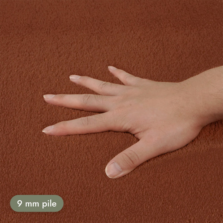 Washmellow terra washable rug, close-up of the soft 9mm pile under a hand | The Rugs