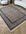 Decorative rug with intricate patterns on a wooden floor