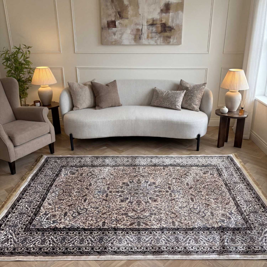 Living room with a patterned rug, sofa, and armchair.
