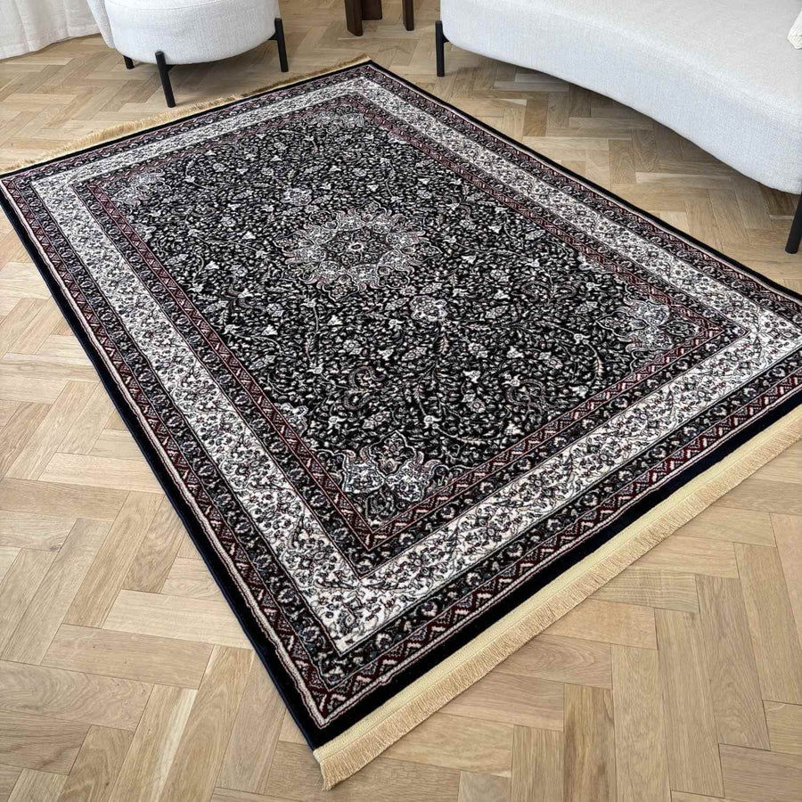 Decorative rug with intricate patterns on a wooden floor