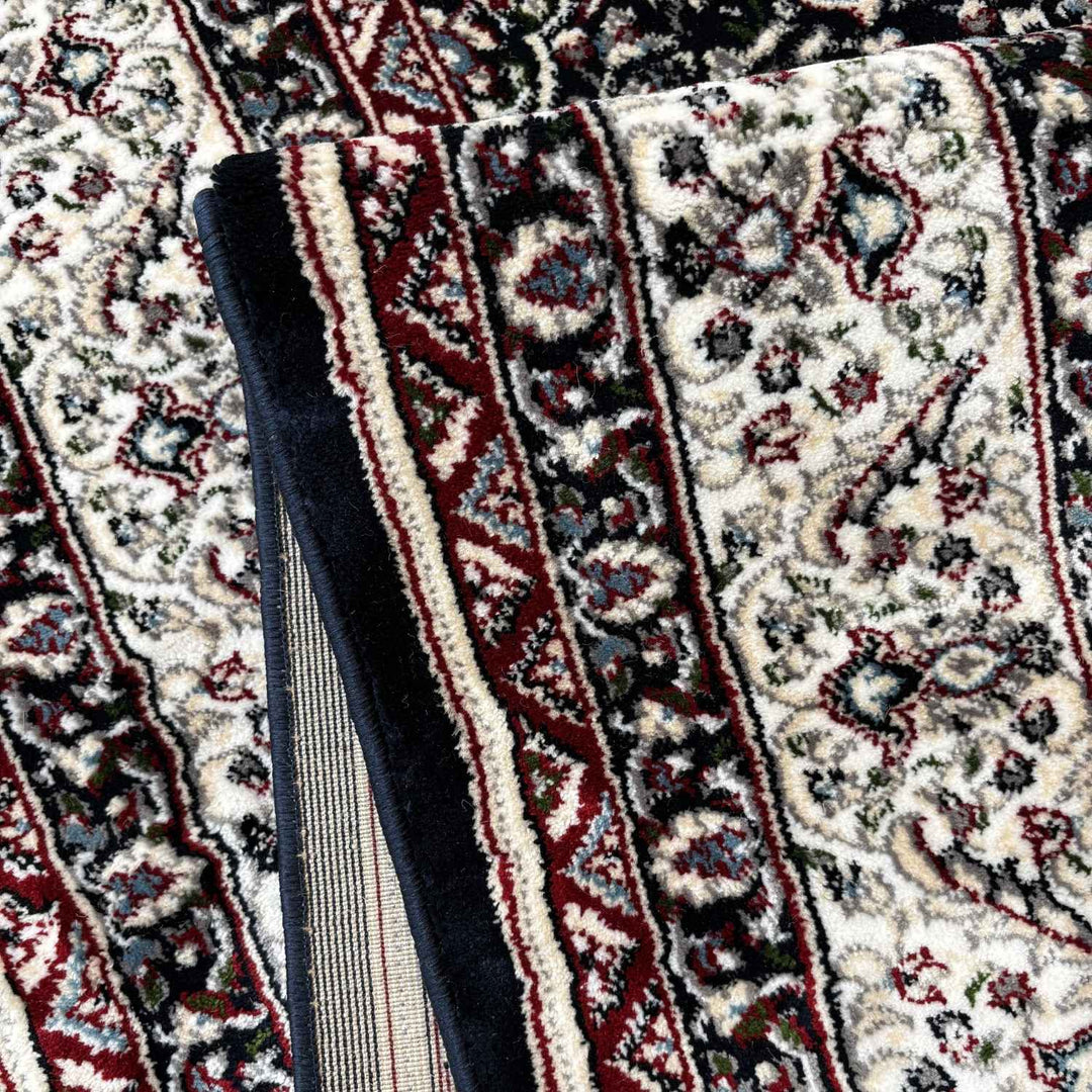 Close-up of patterned rugs with intricate designs on a textured surface.