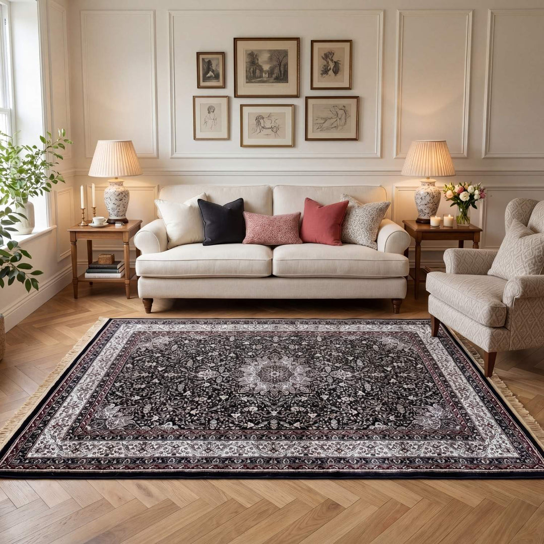 Living room with a decorative rug, sofa, and wall art.