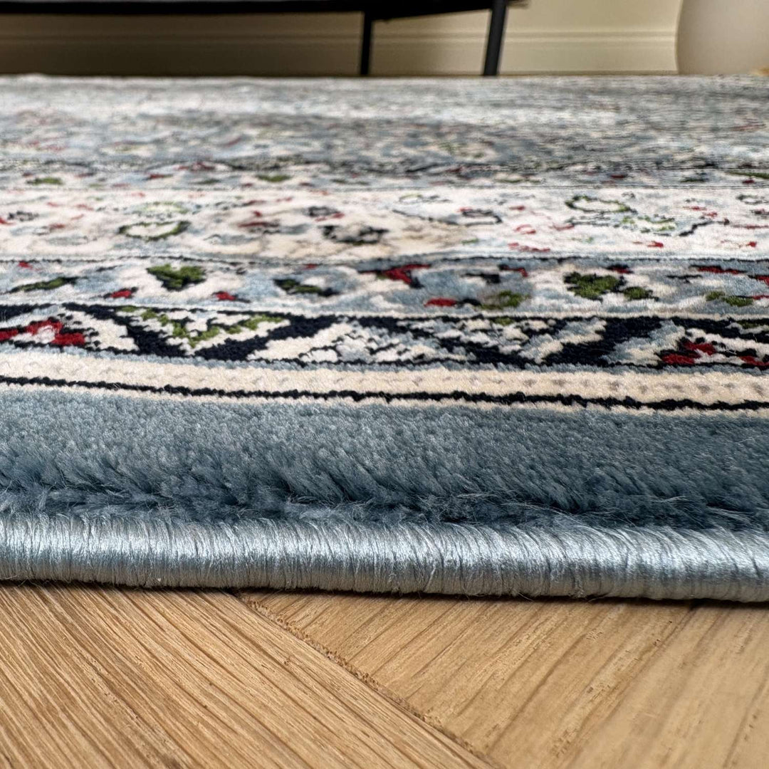 Close-up of a patterned rug on a wooden floor