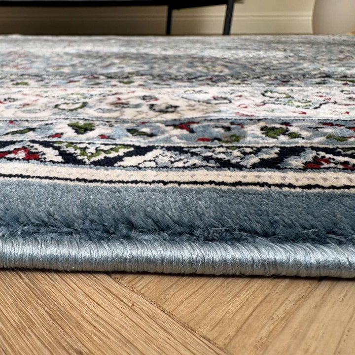 Close-up of a patterned rug on a wooden floor