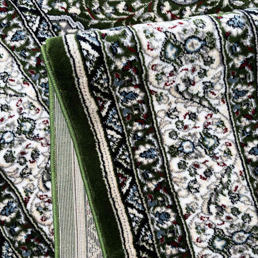 Close-up of a patterned rug with green border