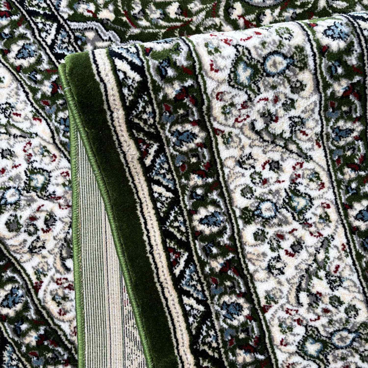 Close-up of a patterned rug with green border