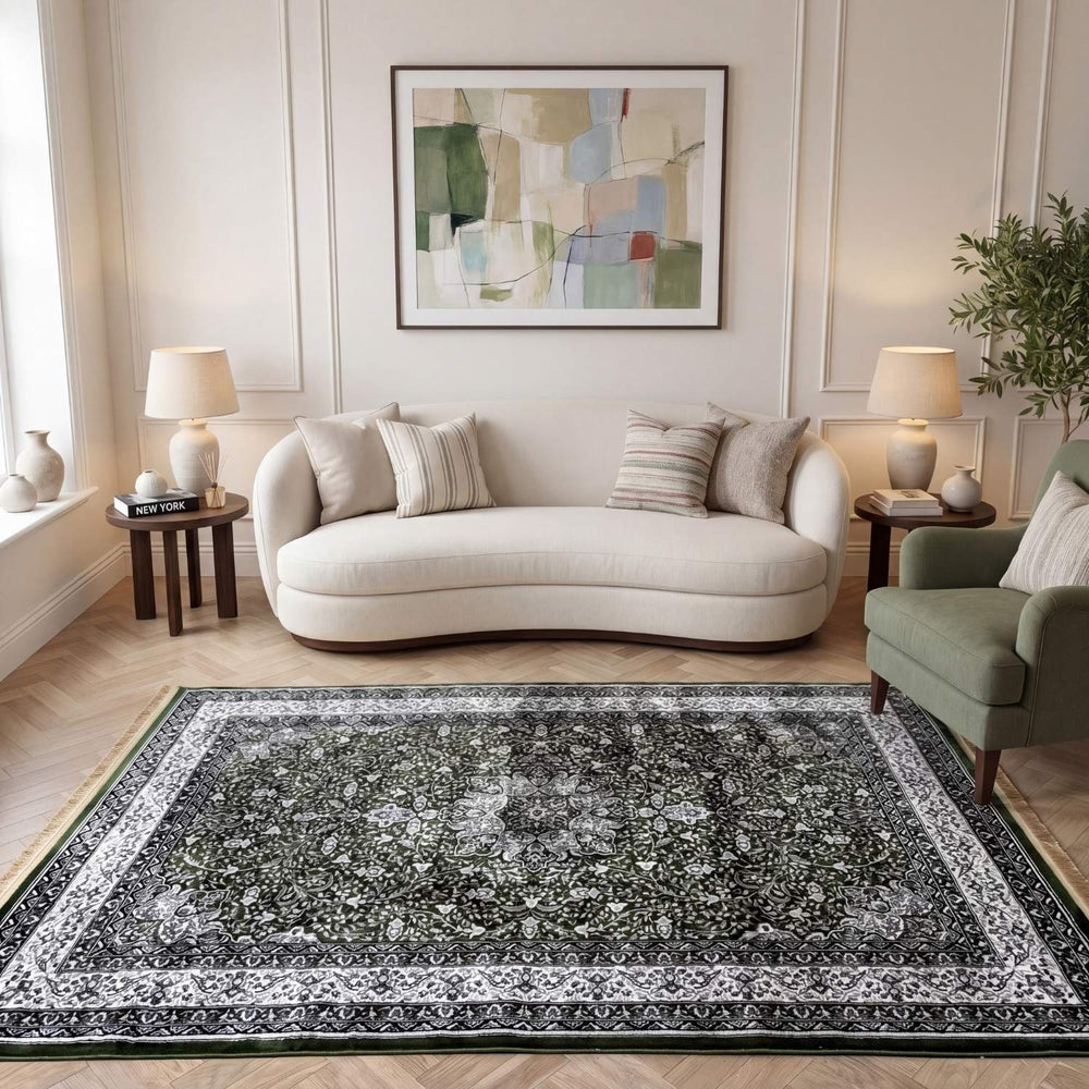 Living room with a gray floral rug, white sofa, and abstract art on the wall.