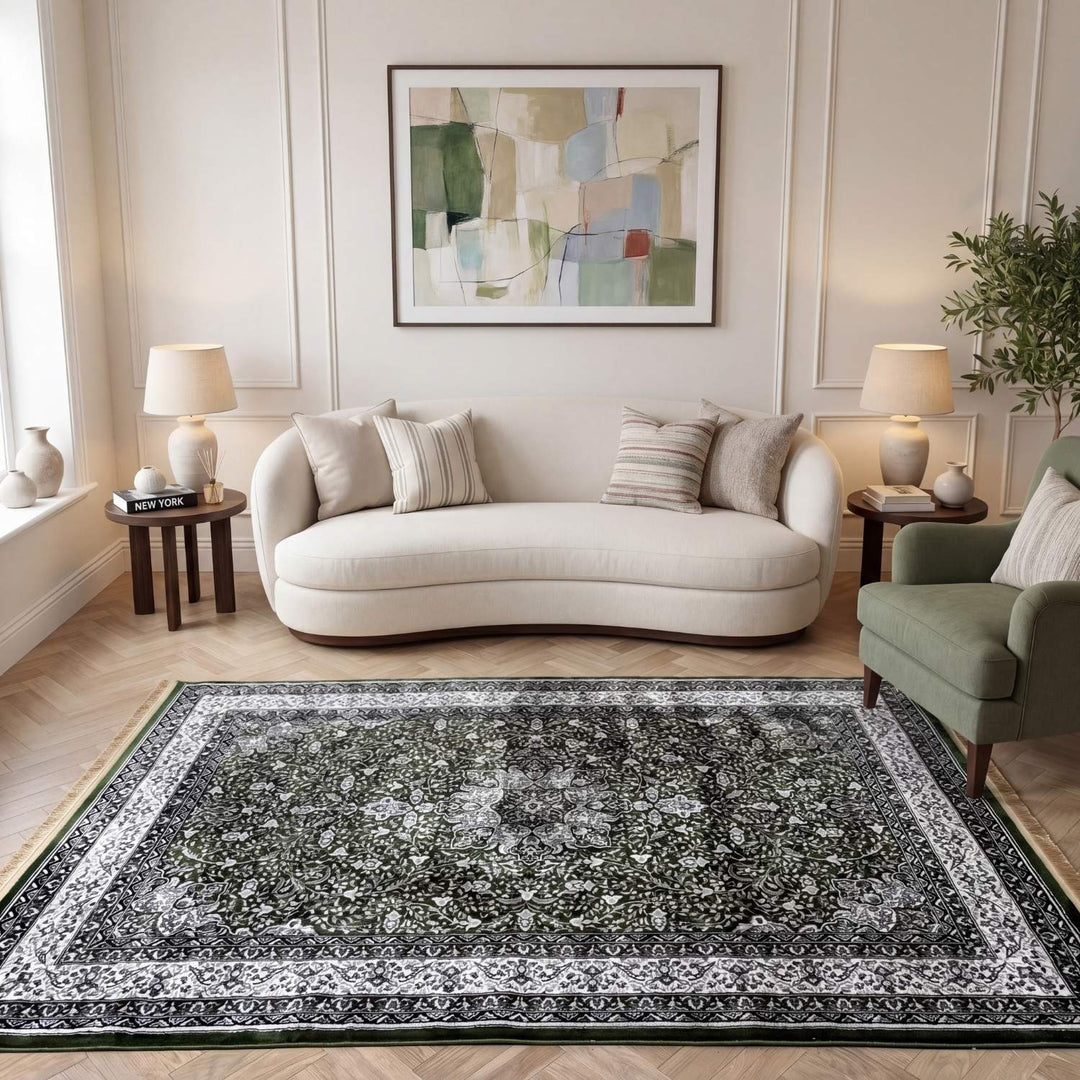 Living room with a gray floral rug, white sofa, and abstract art on the wall.