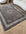 Decorative area rug with intricate patterns on a wooden floor
