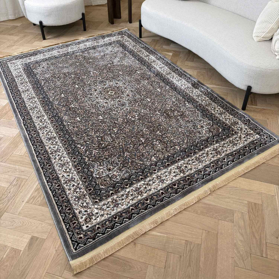 Decorative area rug with intricate patterns on a wooden floor
