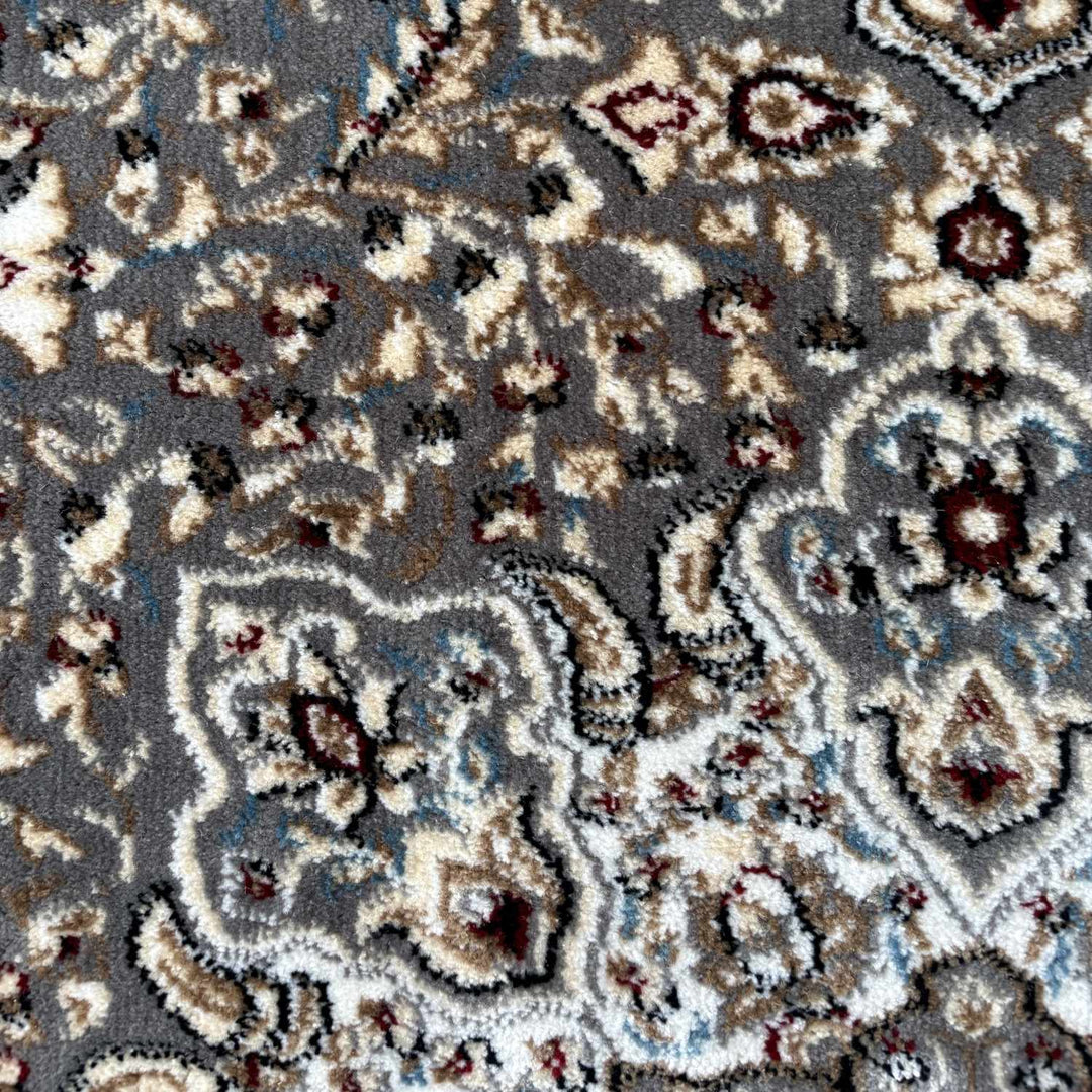 Close-up of a patterned rug with intricate designs.