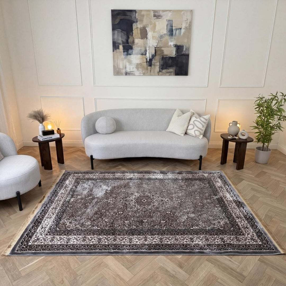 Living room with a gray sofa, decorative rug, and abstract painting on the wall.