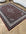 Decorative rug with intricate patterns on a wooden floor