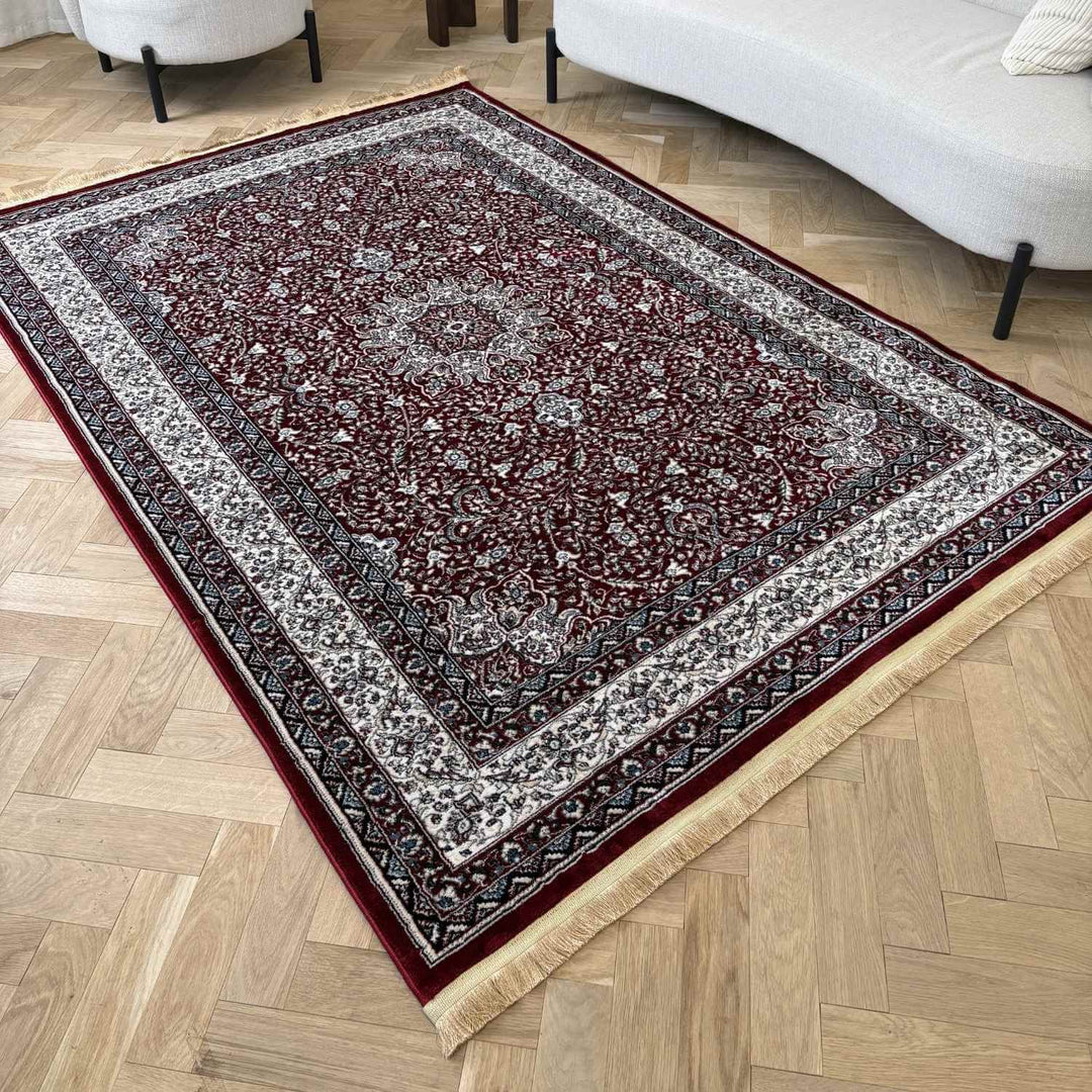 Decorative rug with intricate patterns on a wooden floor