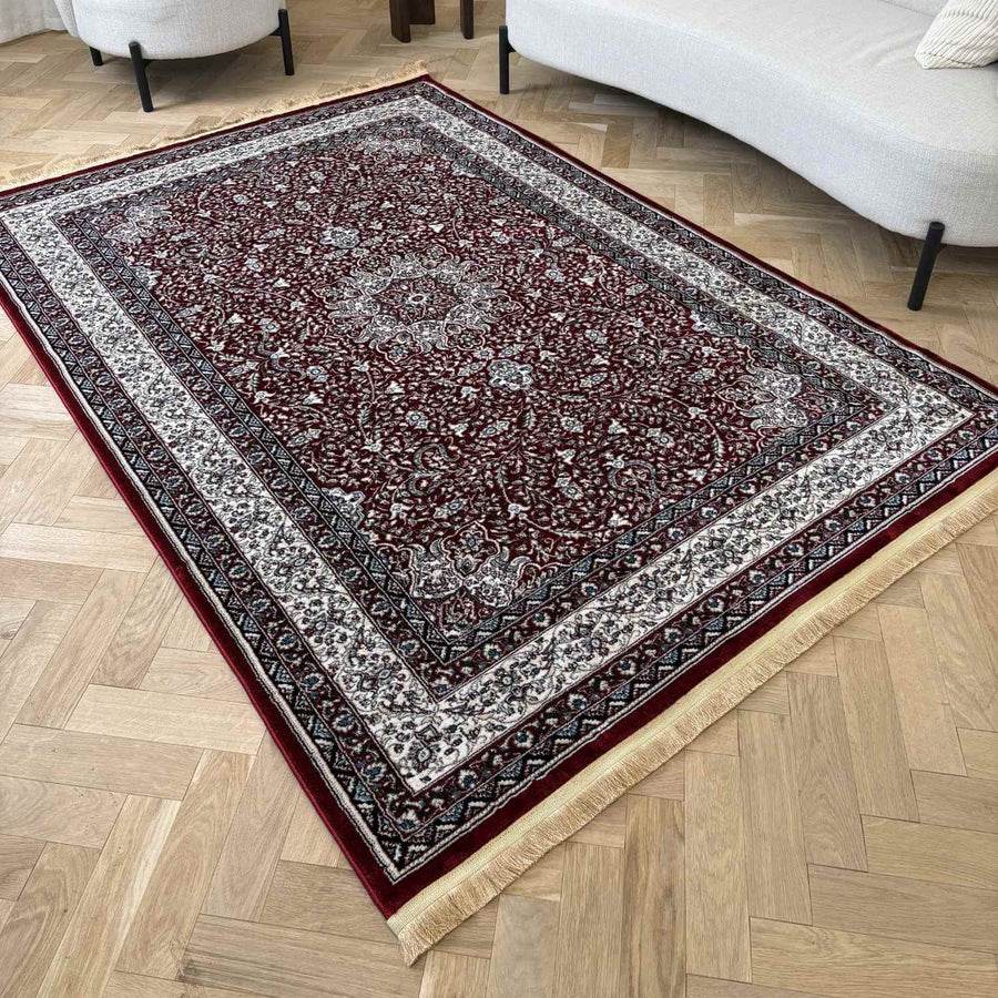 Decorative rug with intricate patterns on a wooden floor