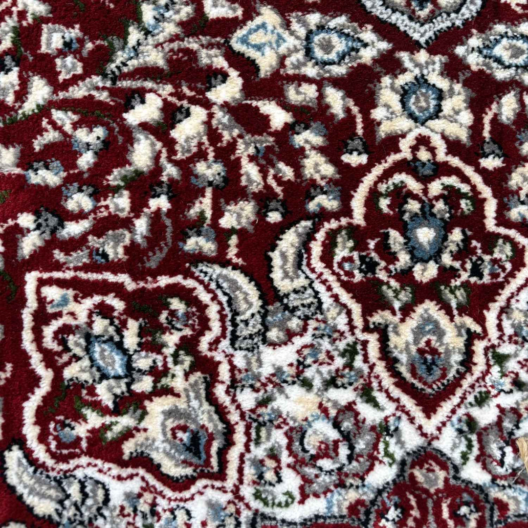 Close-up of a patterned rug with red, white, and blue colors.