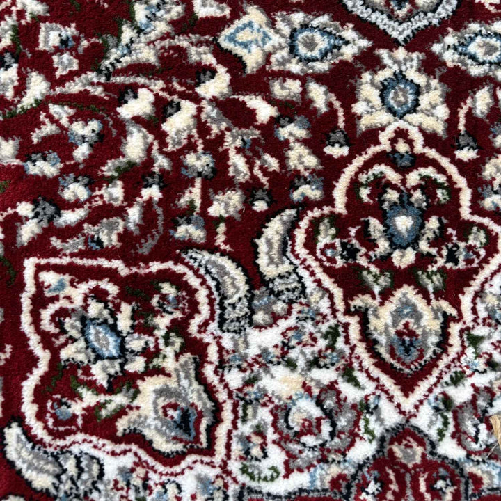 Close-up of a patterned rug with red, white, and blue colors.