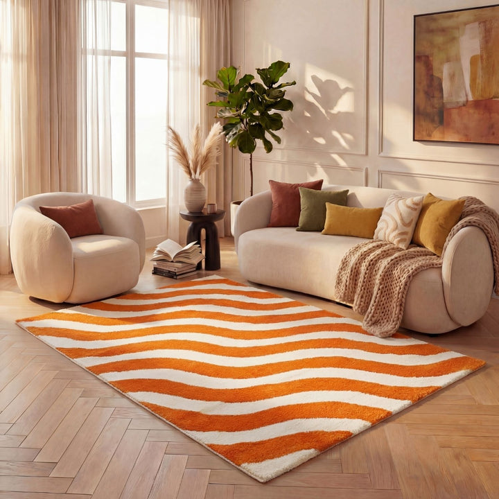 Living room with a striped orange and white rug, beige sofa, and decorative items.