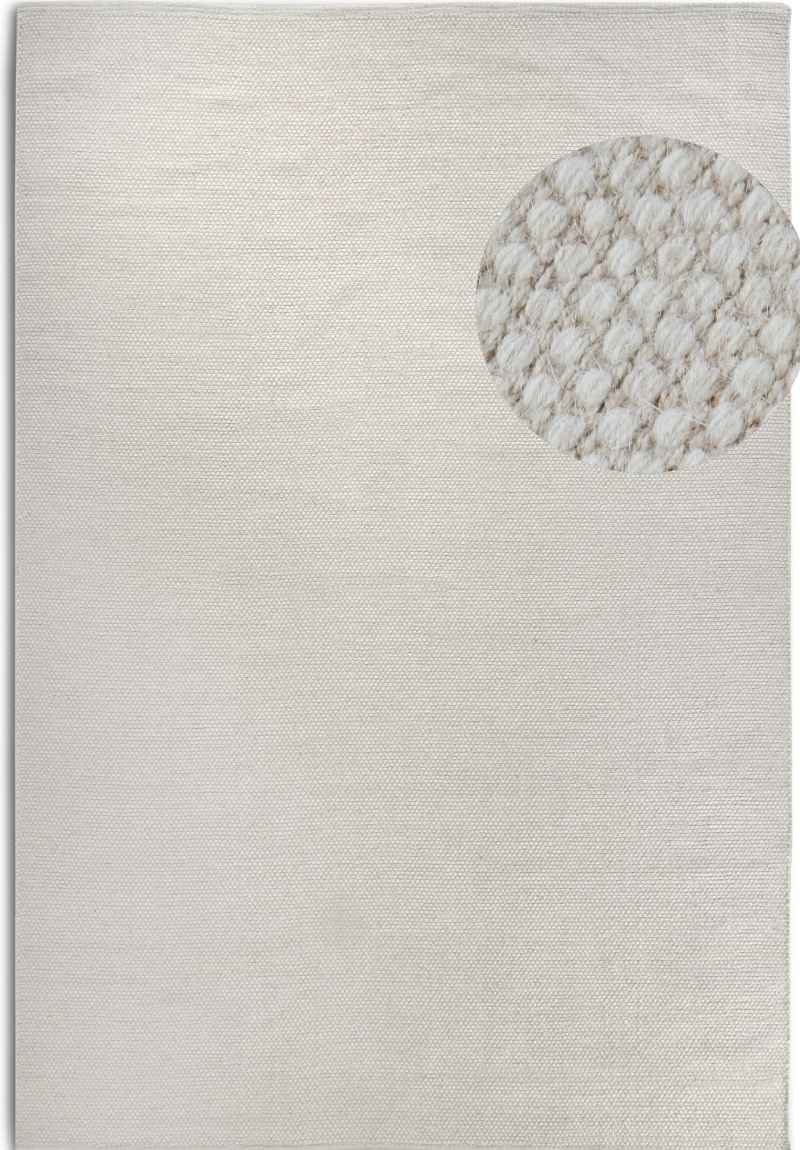 Textured area rug with a circular pattern on a plain background
