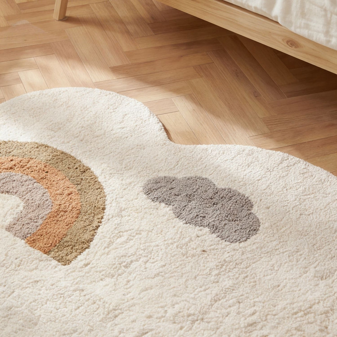 Round white rug with rainbow and cloud pattern on a wooden floor