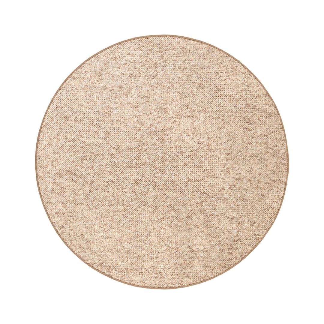 Round beige rug on a white background