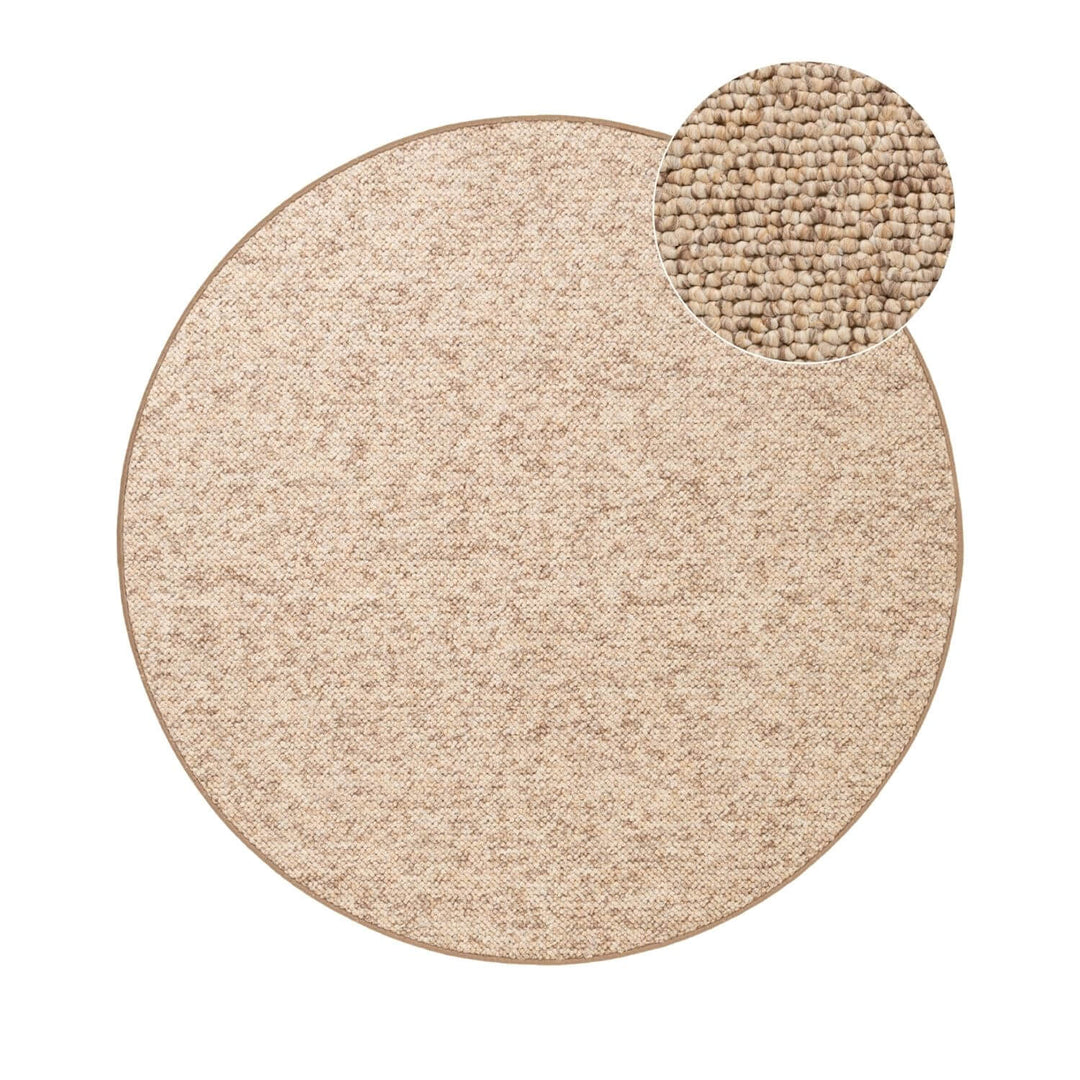 Round beige rug with a textured circular mat on a white background