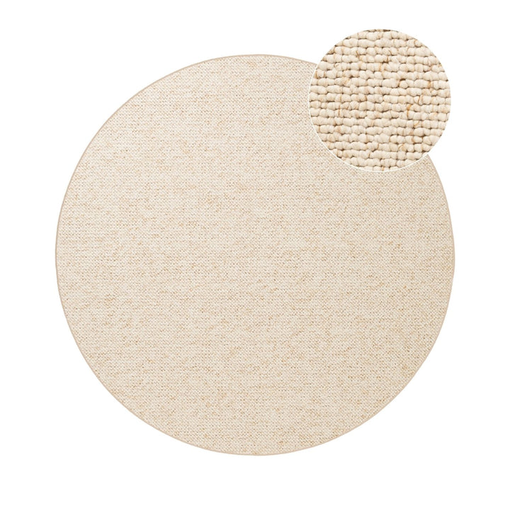 Beige round rug with a smaller round beige rug on top, on a white background