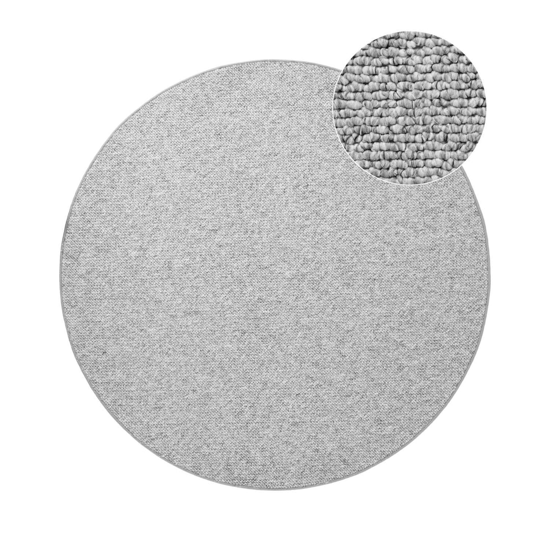 Round gray rug with a textured circular detail on a white background