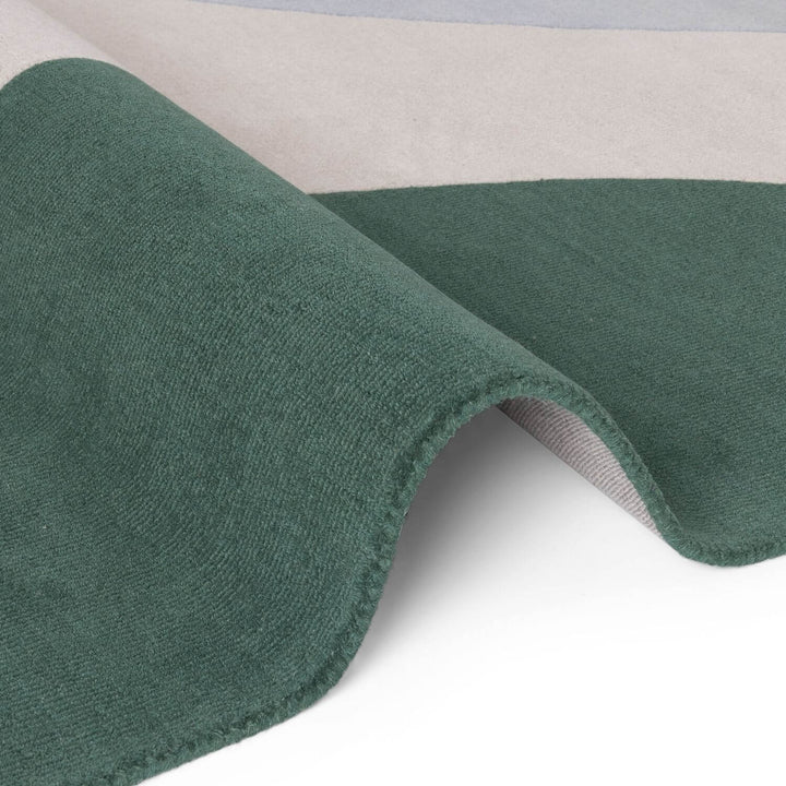 Close-up of green fabric with a textured surface on a white background