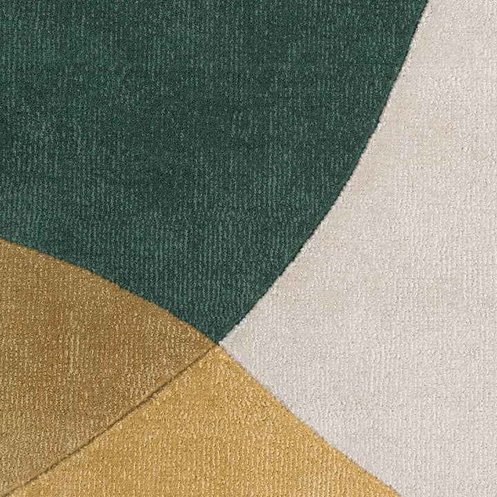 Close-up of a textured fabric with green, gold, and beige colors.